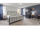 Comfortable bedroom with a dark accent wall and a bathroom view at 1526 Millrock Trl, Wendell, NC 27591