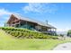 Spacious community clubhouse featuring a modern design, large windows, and an inviting outdoor seating area with a manicured lawn at 1526 Millrock Trl, Wendell, NC 27591