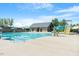 Community pool with water slides, lap lanes, and deck space, complete with umbrellas, and surrounded by a fence at 1526 Millrock Trl, Wendell, NC 27591