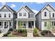 Charming two-story home featuring a covered front porch and beautifully landscaped yard with colorful flowers at 1526 Millrock Trl, Wendell, NC 27591