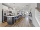 Open concept kitchen features a large island with seating, stainless appliances, and wood flooring at 1526 Millrock Trl, Wendell, NC 27591