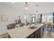 Open kitchen with a large island, pendant lighting, barstool seating, and modern fixtures at 1526 Millrock Trl, Wendell, NC 27591