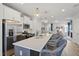 Modern kitchen with white cabinets, stainless steel appliances, a large island, and stylish pendant lights at 1526 Millrock Trl, Wendell, NC 27591