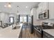 Modern kitchen boasts stainless steel appliances, quartz countertops, and stylish pendant lighting at 1526 Millrock Trl, Wendell, NC 27591