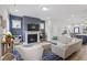 Comfortable living room with a fireplace, stylish furniture, and a blue accent wall with a modern aesthetic at 1526 Millrock Trl, Wendell, NC 27591
