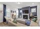 Cozy living room features a fireplace, large windows, and comfortable seating at 1526 Millrock Trl, Wendell, NC 27591