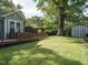 Large backyard and well-manicured lawn leads to the wood porch, side yard and storage shed at 1811 Park Dr, Raleigh, NC 27605