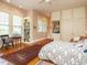 Bedroom featuring hardwood floors, built-in shelving, an armoire, a ceiling fan, and plenty of natural light at 1811 Park Dr, Raleigh, NC 27605
