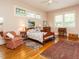 Comfortable bedroom with natural light, hardwood floors, a ceiling fan, and multiple windows at 1811 Park Dr, Raleigh, NC 27605