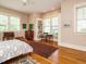 Bedroom featuring hardwood floors, a ceiling fan, a bookcase, a desk and lots of natural light at 1811 Park Dr, Raleigh, NC 27605