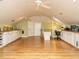 Spacious bonus room with hardwood flooring, white cabinetry, sink and ample countertop space at 1811 Park Dr, Raleigh, NC 27605