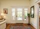 Bright entryway featuring hardwood floors, decorative rug, and a charming view through the front door at 1811 Park Dr, Raleigh, NC 27605