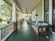 Relaxing front porch with a cozy bench, overhead fan, and serene outdoor ambiance at 1811 Park Dr, Raleigh, NC 27605