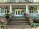 Welcoming front porch featuring classic columns, a fan, and a view of the address number '1811' at 1811 Park Dr, Raleigh, NC 27605