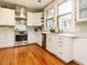 Bright kitchen with stainless steel appliances, white cabinets, and hardwood floors at 1811 Park Dr, Raleigh, NC 27605