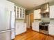 Updated kitchen with stainless steel appliances, white cabinets, and hardwood floors at 1811 Park Dr, Raleigh, NC 27605