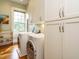 Convenient laundry room featuring a washer and dryer, ample cabinet space and lots of shelving at 1811 Park Dr, Raleigh, NC 27605