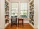 Charming study featuring hardwood floors, built in shelving, and a view of the landscaped backyard at 1811 Park Dr, Raleigh, NC 27605