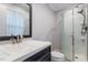 Stylish bathroom featuring a sink with dark cabinets and a shower with modern fixtures at 1813 Grady Dr, Durham, NC 27712
