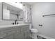 Modern bathroom featuring grey vanity, updated fixtures, a spacious shower, and contemporary design elements at 1813 Grady Dr, Durham, NC 27712
