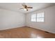 Bright bedroom features wood floors, a ceiling fan, and a window at 1813 Grady Dr, Durham, NC 27712