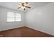 Bright bedroom with laminate flooring, a ceiling fan, and a window with blinds at 1813 Grady Dr, Durham, NC 27712