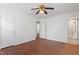 Comfortable bedroom featuring wood floors, ceiling fan, closet and adjoining bath at 1813 Grady Dr, Durham, NC 27712
