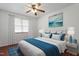 Bedroom with a large window, hardwood floors, a queen-sized bed with night stands and lamps at 1813 Grady Dr, Durham, NC 27712