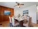 Cozy dining room featuring wood paneling, a modern light fixture, and a marble table with seating for six at 1813 Grady Dr, Durham, NC 27712