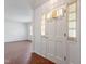 Bright entryway featuring light walls and trim, leading to living area with wood laminate flooring at 1813 Grady Dr, Durham, NC 27712