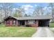 Charming one-story brick house with a well-maintained lawn and cozy carport at 1813 Grady Dr, Durham, NC 27712