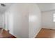 Hallway featuring neutral walls and wood laminate flooring, leading to other rooms at 1813 Grady Dr, Durham, NC 27712