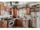 Charming kitchen with wood cabinets, stainless steel appliances, and lots of plants at 1813 Grady Dr, Durham, NC 27712