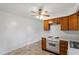 Kitchen featuring wooden cabinets, white countertops, and a ceiling fan with a light fixture at 1813 Grady Dr, Durham, NC 27712