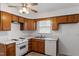 Charming kitchen featuring wooden cabinets, white countertops, and standard appliances at 1813 Grady Dr, Durham, NC 27712
