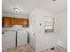 Functional laundry room with a washer, dryer, upper cabinets, and window for natural light at 1813 Grady Dr, Durham, NC 27712