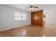 Living room with wood laminate flooring, paneling, and a glimpse into the kitchen at 1813 Grady Dr, Durham, NC 27712