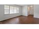 Inviting living room featuring hardwood floors and sunlit window with white trim at 1813 Grady Dr, Durham, NC 27712