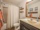 Well-lit bathroom featuring a shower, tub, tile floors, and an ample vanity at 198 Shadowbark Dr, Garner, NC 27529