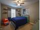 bedroom with blue bedspread, ceiling fan, window and playful decor at 198 Shadowbark Dr, Garner, NC 27529