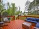 Red-stained wood deck featuring outdoor seating and tree-lined backyard at 198 Shadowbark Dr, Garner, NC 27529