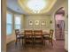 Dining room features a trey ceiling, natural light, with an archway into the kitchen at 198 Shadowbark Dr, Garner, NC 27529
