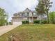 Beautiful two-story home with attached two car garage, manicured front lawn, and inviting entryway at 198 Shadowbark Dr, Garner, NC 27529