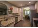 Eat-in kitchen featuring granite counters, stainless appliances, white cabinetry and an archway into the dining room at 198 Shadowbark Dr, Garner, NC 27529
