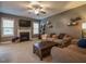 Cozy living room with fireplace, plush seating, and abundant natural light creates a warm atmosphere at 198 Shadowbark Dr, Garner, NC 27529