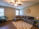 Inviting living room featuring a plush sectional sofa, area rug, and natural light at 198 Shadowbark Dr, Garner, NC 27529