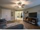 Comfortable living room with entertainment center, closet, and view to bedroom at 198 Shadowbark Dr, Garner, NC 27529