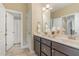 Bathroom features a double vanity, a large mirror, and a tiled shower for a refreshing experience at 2000 Monthaven Dr, Wake Forest, NC 27587