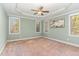 Bright primary bedroom with tray ceiling, carpeted floors, and multiple windows with natural light at 2000 Monthaven Dr, Wake Forest, NC 27587