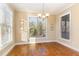 Dining room with hardwood floors, natural light, modern chandelier, and neutral wall color at 2000 Monthaven Dr, Wake Forest, NC 27587